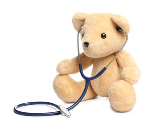 Photo of Pediatrics concept. Teddy bear with stethoscope isolated on white