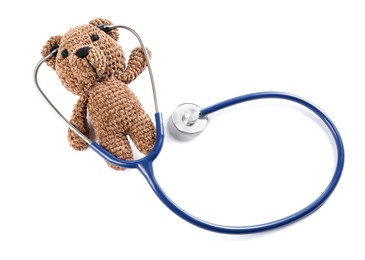 Photo of Pediatrics concept. Toy bear with stethoscope isolated on white, top view