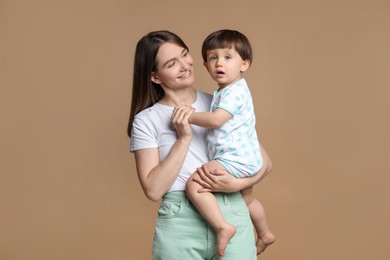 Photo of Family portrait of happy mother with her little son on beige background