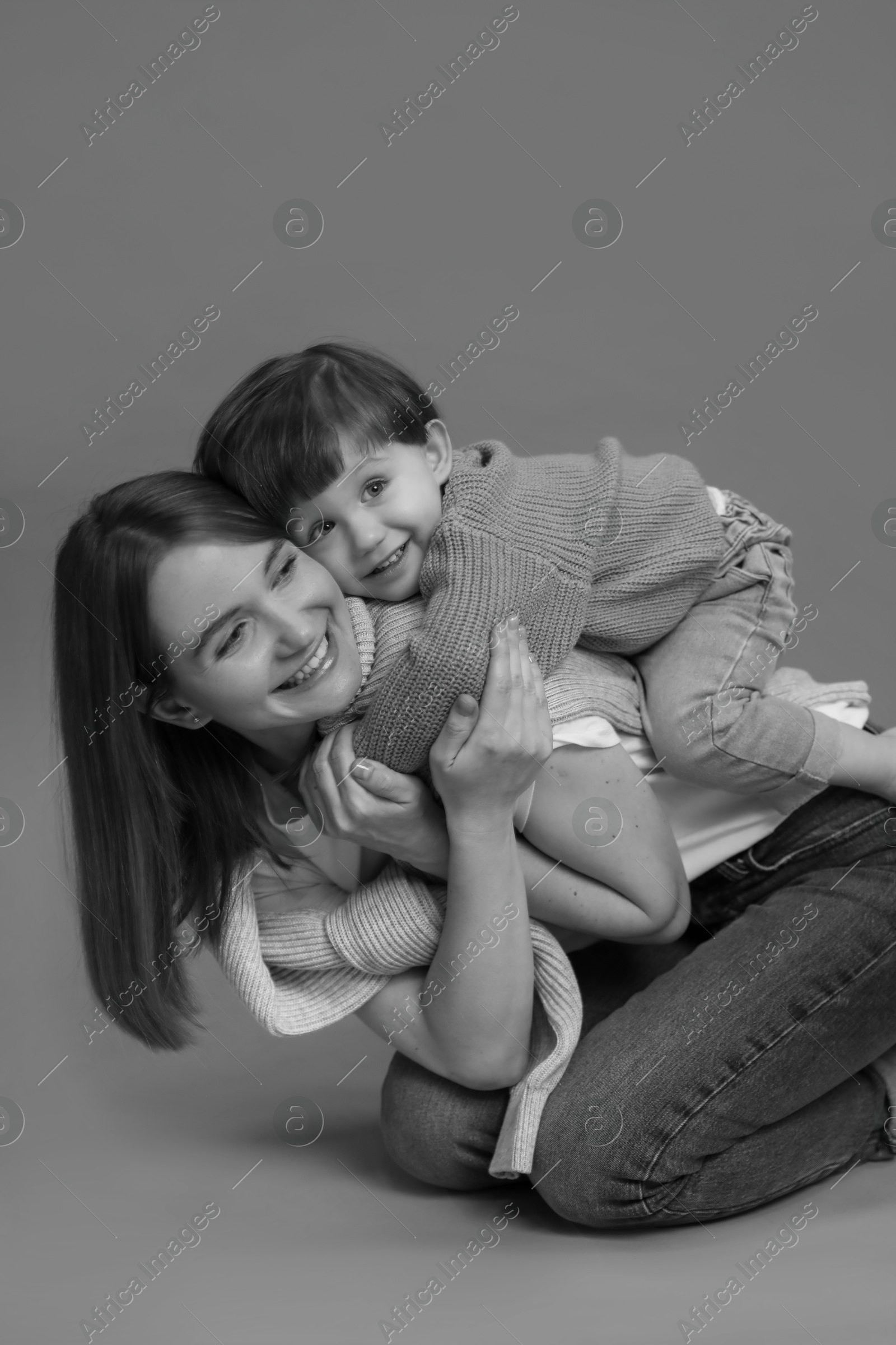 Photo of Happy mother with her little son, black and white effect