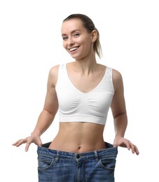 Photo of Weight loss. Happy woman wearing big jeans on white background