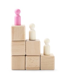 Photo of Human figures on wooden blocks, pink one on top against white background. Competition concept