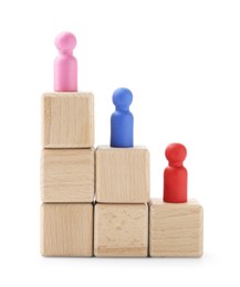 Photo of Human figures on wooden blocks, pink one on top against white background. Competition concept