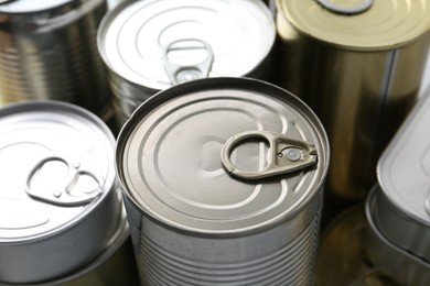 Photo of Many closed tin cans as background, closeup