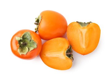 Photo of Whole and cut fresh persimmons isolated on white, top view