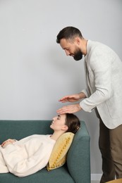 Photo of Psychologist working with patient during hypnosis session indoors