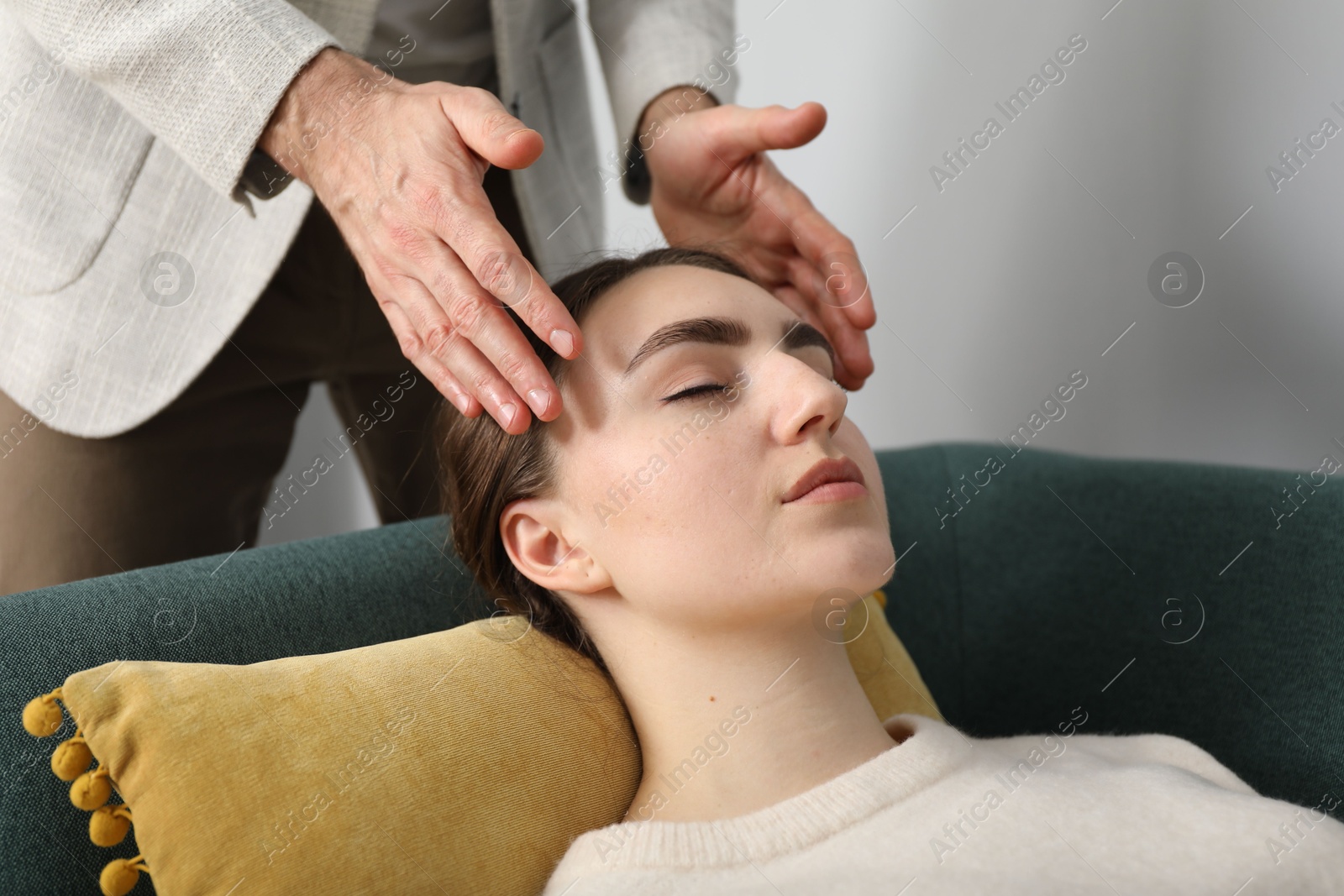 Photo of Psychologist working with patient during hypnosis session indoors, closeup