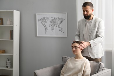 Psychologist working with patient during hypnosis session indoors