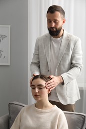 Psychologist working with patient during hypnosis session indoors