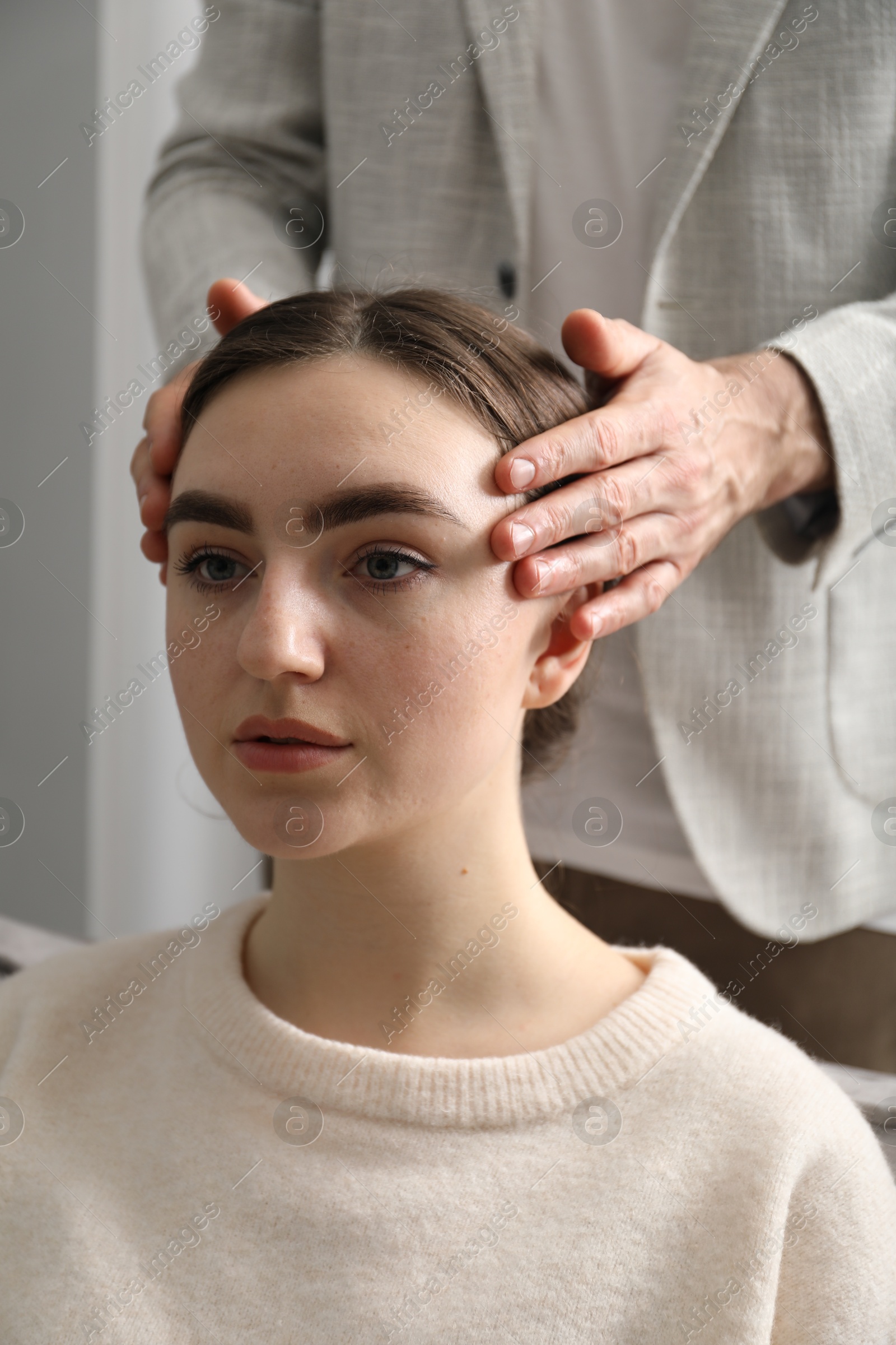 Photo of Psychologist working with patient during hypnosis session indoors, closeup