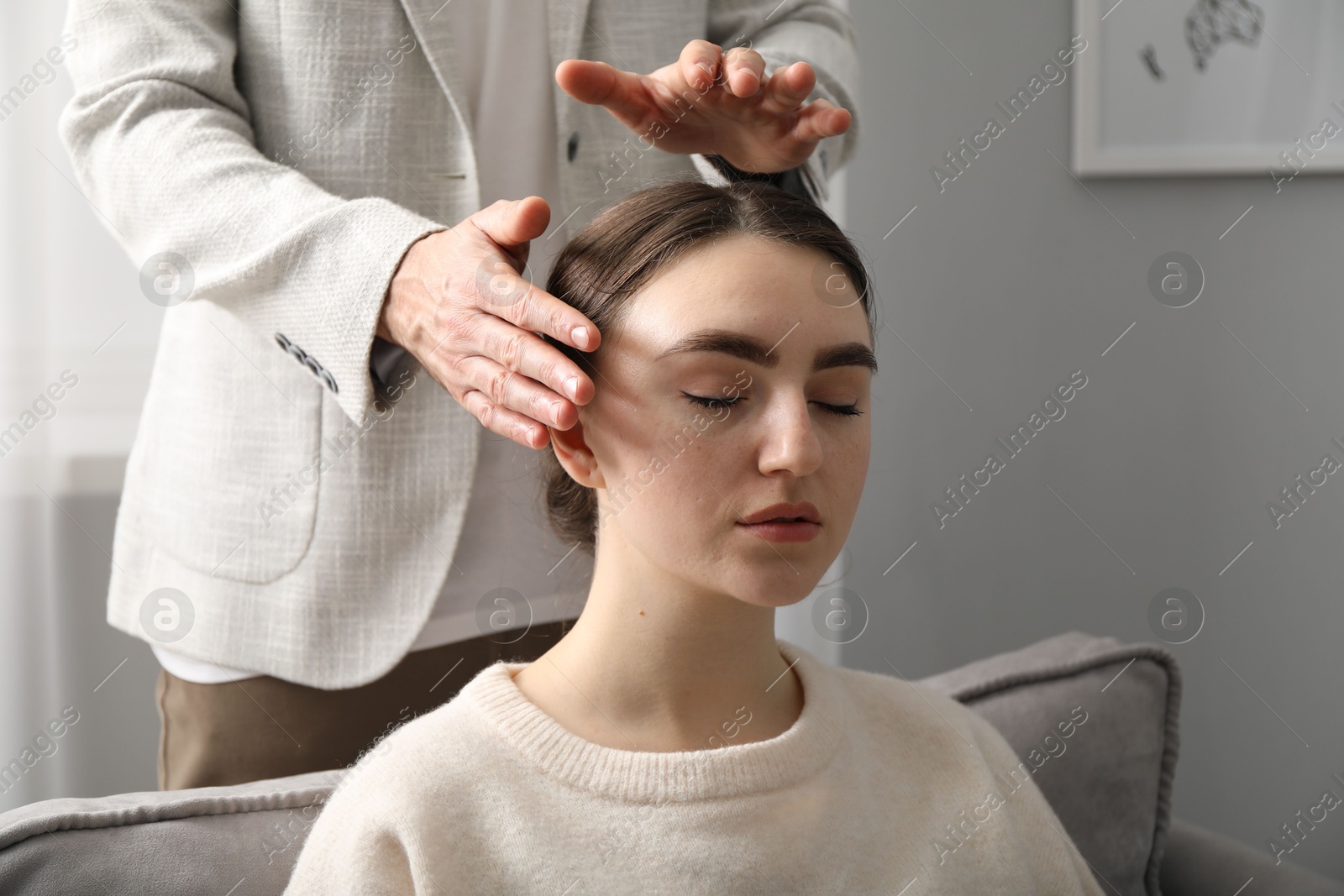 Photo of Psychologist working with patient during hypnosis session indoors, closeup