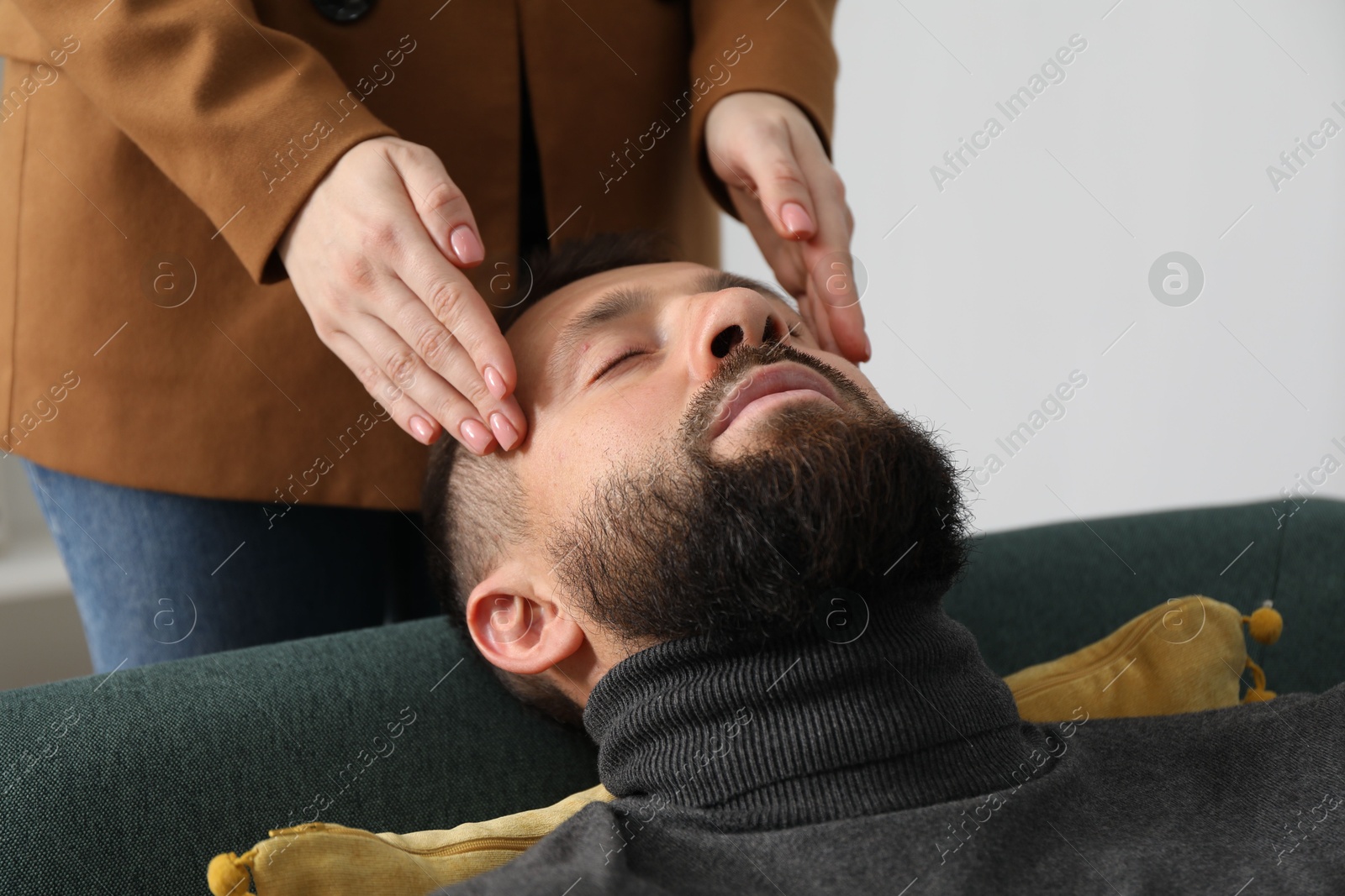 Photo of Psychologist working with patient during hypnosis session indoors, closeup