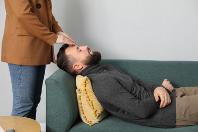 Photo of Psychologist working with patient during hypnosis session indoors, closeup