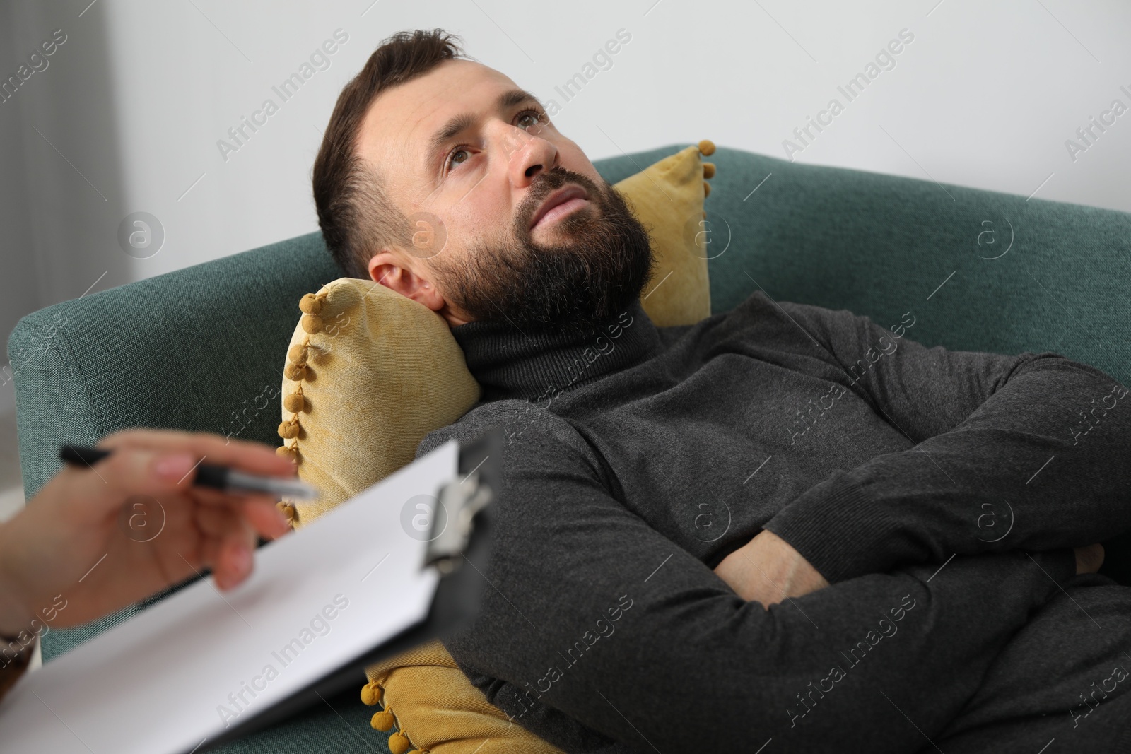 Photo of Psychologist working with patient during hypnosis session indoors, closeup