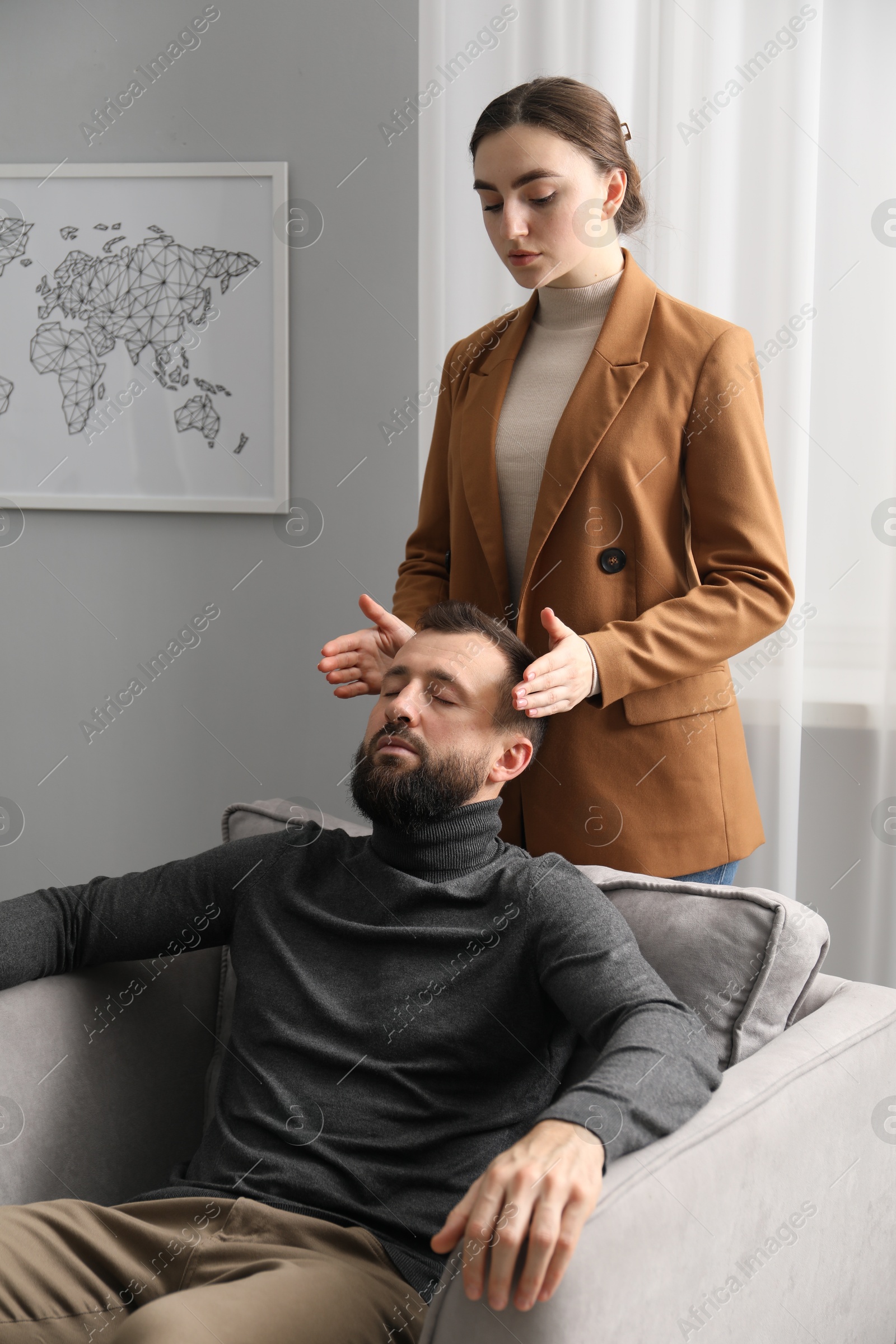 Photo of Psychologist working with patient during hypnosis session indoors