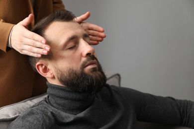 Photo of Psychologist working with patient during hypnosis session indoors, closeup