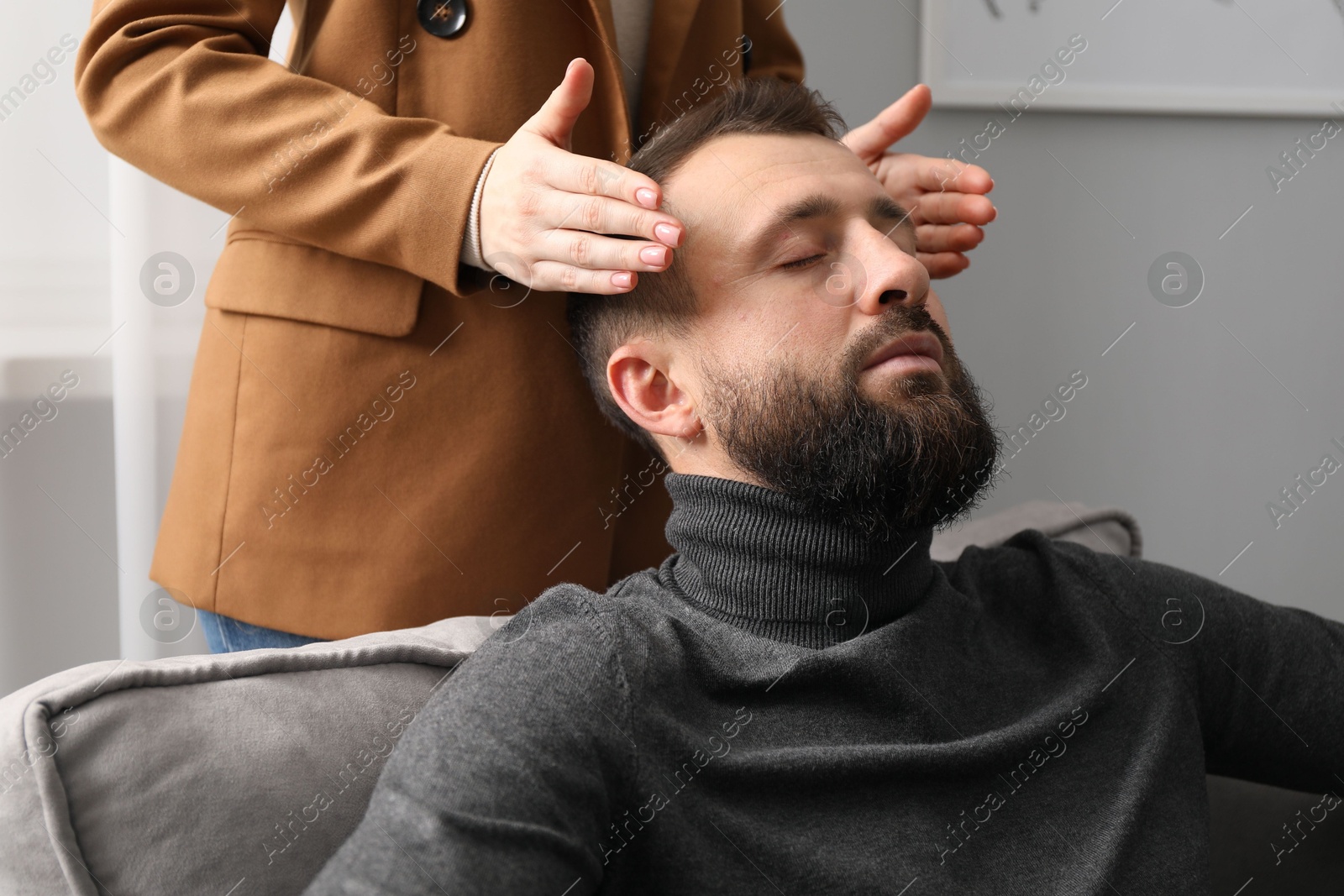 Photo of Psychologist working with patient during hypnosis session indoors, closeup