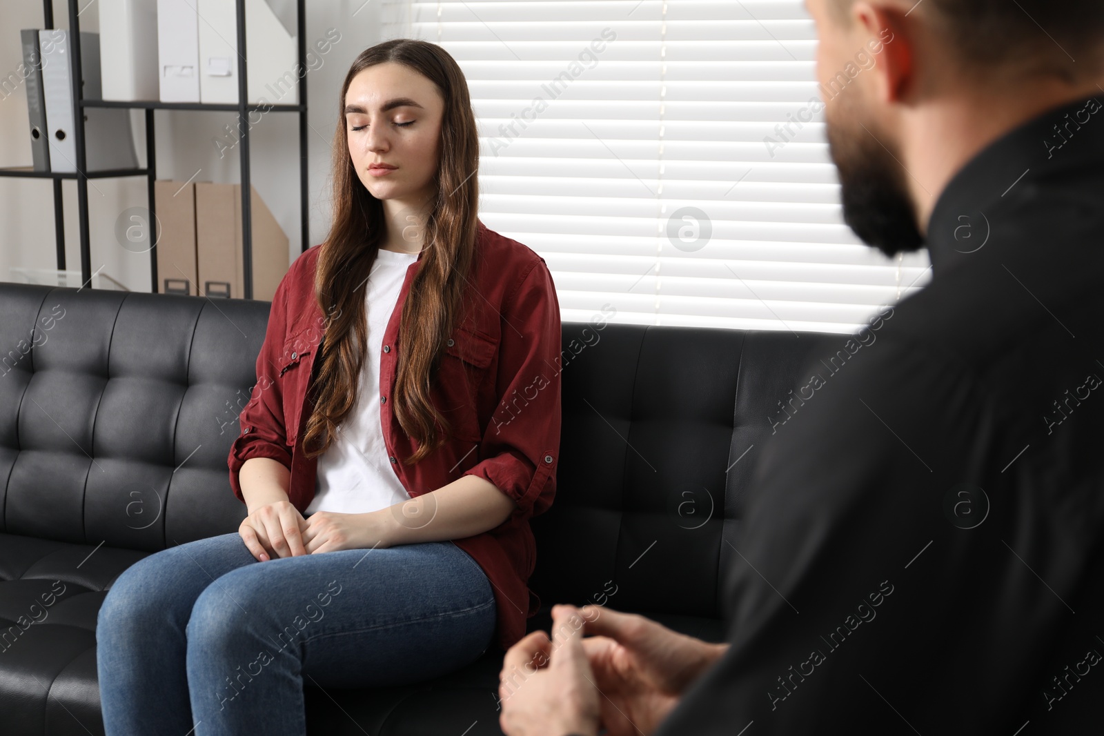 Photo of Psychologist working with patient during hypnosis session indoors, closeup