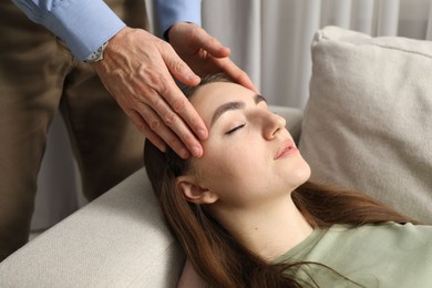 Photo of Psychologist working with patient during hypnosis session indoors, closeup