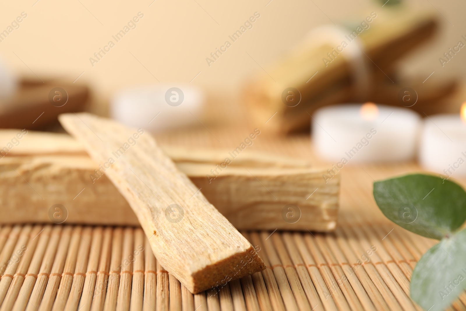 Photo of Palo santo sticks on bamboo mat, closeup