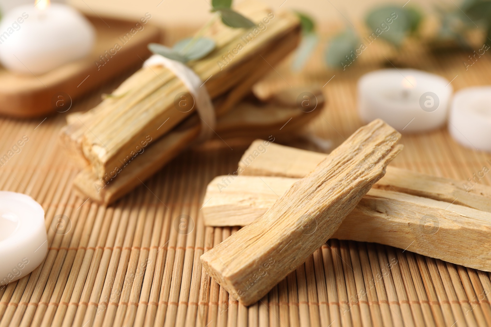 Photo of Palo santo sticks on bamboo mat, closeup