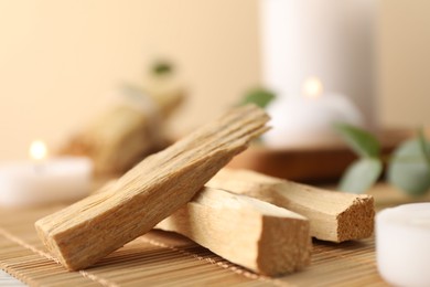 Photo of Palo santo sticks on bamboo mat, closeup