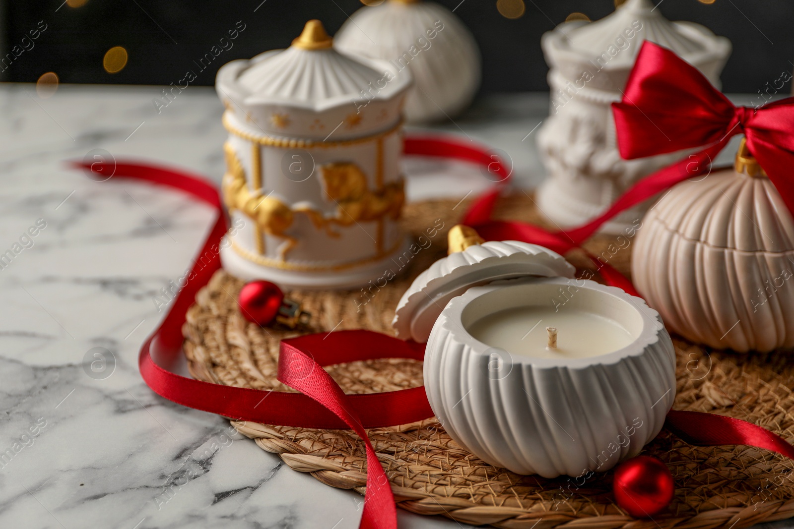 Photo of Soy wax candles on white marble table, closeup. Beautiful Christmas decor