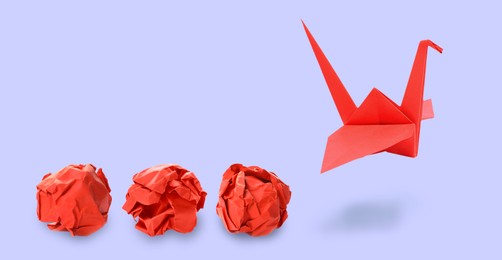 Image of Red origami crane and crumpled paper balls on grey background, banner design. Transformation or new ideas concept