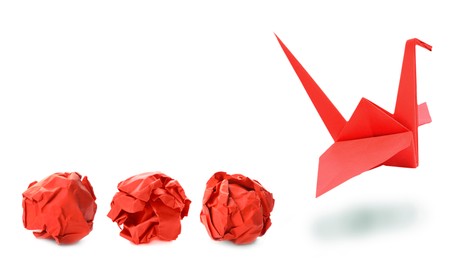 Image of Red origami crane and crumpled paper balls on white background, banner design. Transformation or new ideas concept