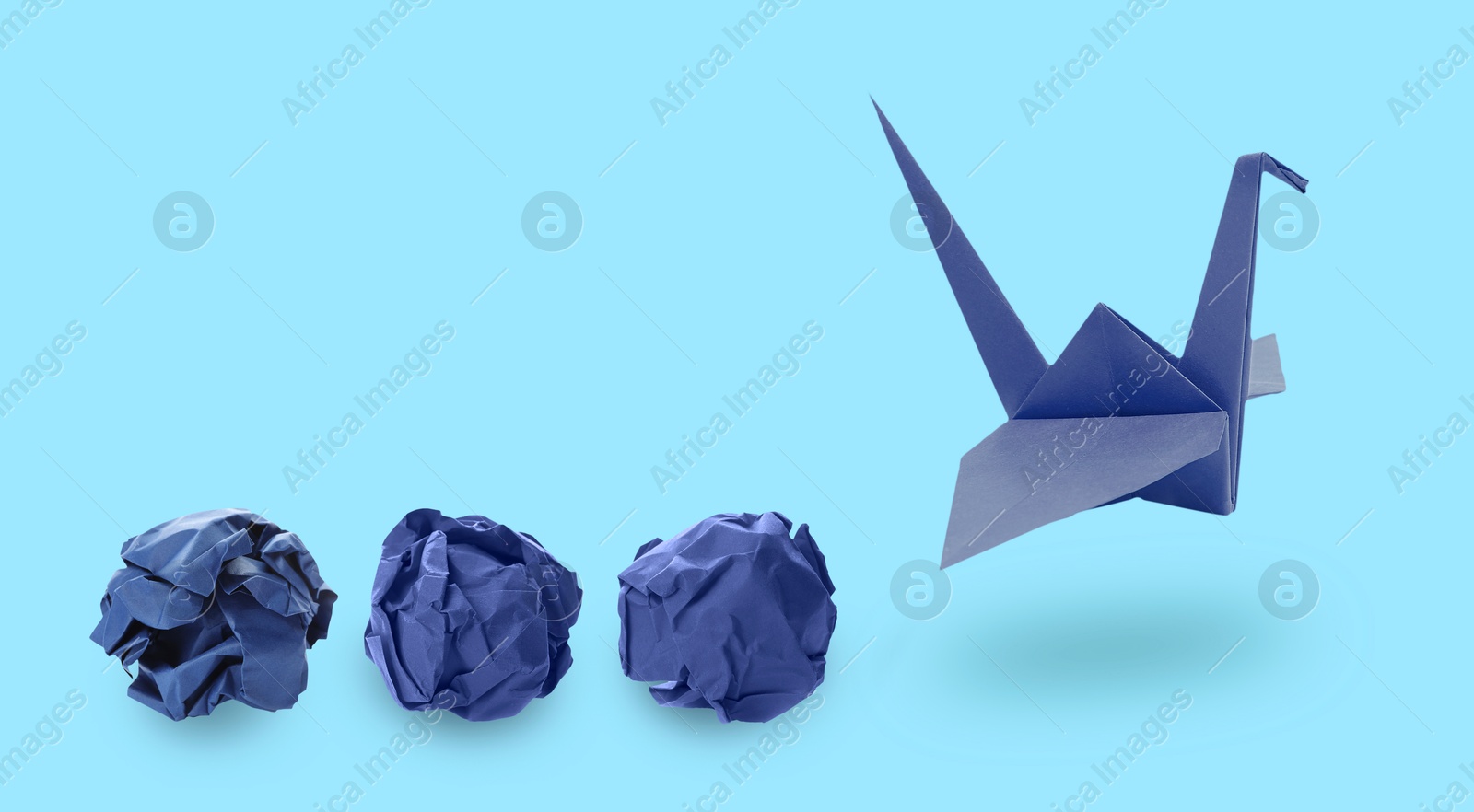 Image of Origami crane and crumpled paper balls on light blue background, banner design. Transformation or new ideas concept