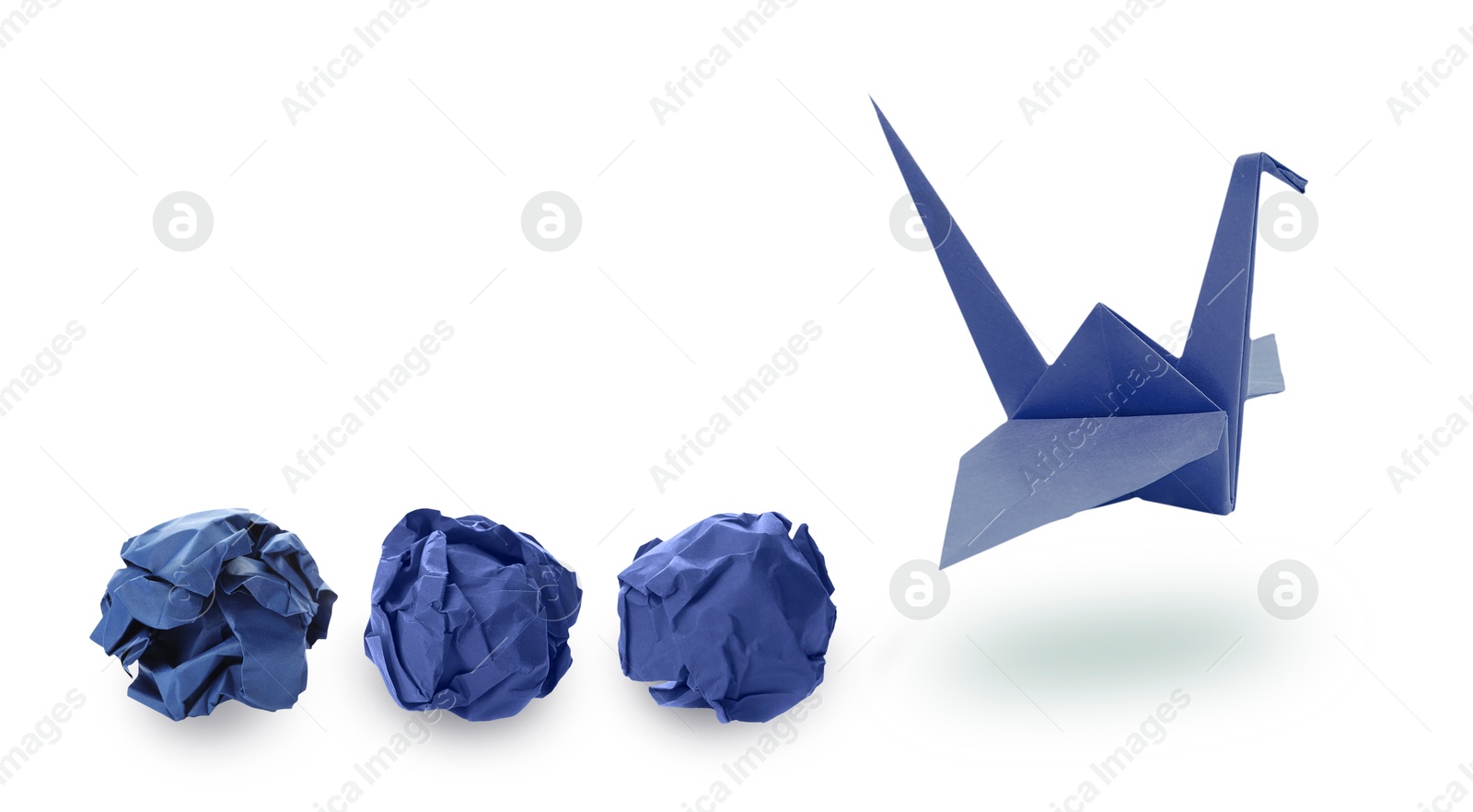 Image of Blue origami crane and crumpled paper balls on white background, banner design. Transformation or new ideas concept