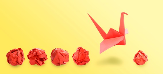 Image of Red origami crane and crumpled paper balls on yellow gradient background, banner design. Transformation or leadership concept