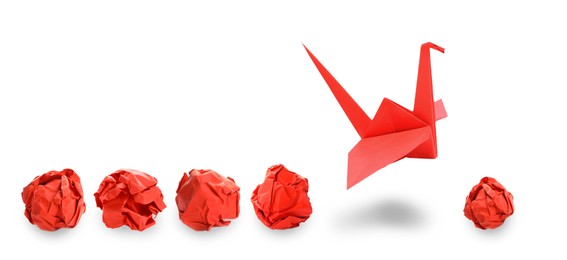 Image of Red origami crane and crumpled paper balls on white background, banner design. Transformation or leadership concept