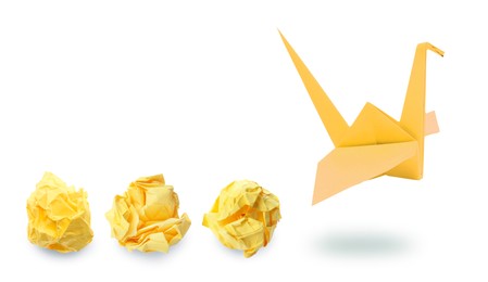 Image of Yellow origami crane and crumpled paper balls on white background, banner design. Transformation or new ideas concept