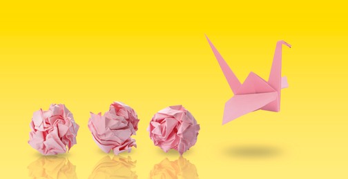 Image of Pink origami crane and crumpled paper balls on yellow gradient background, banner design. Transformation or new ideas concept