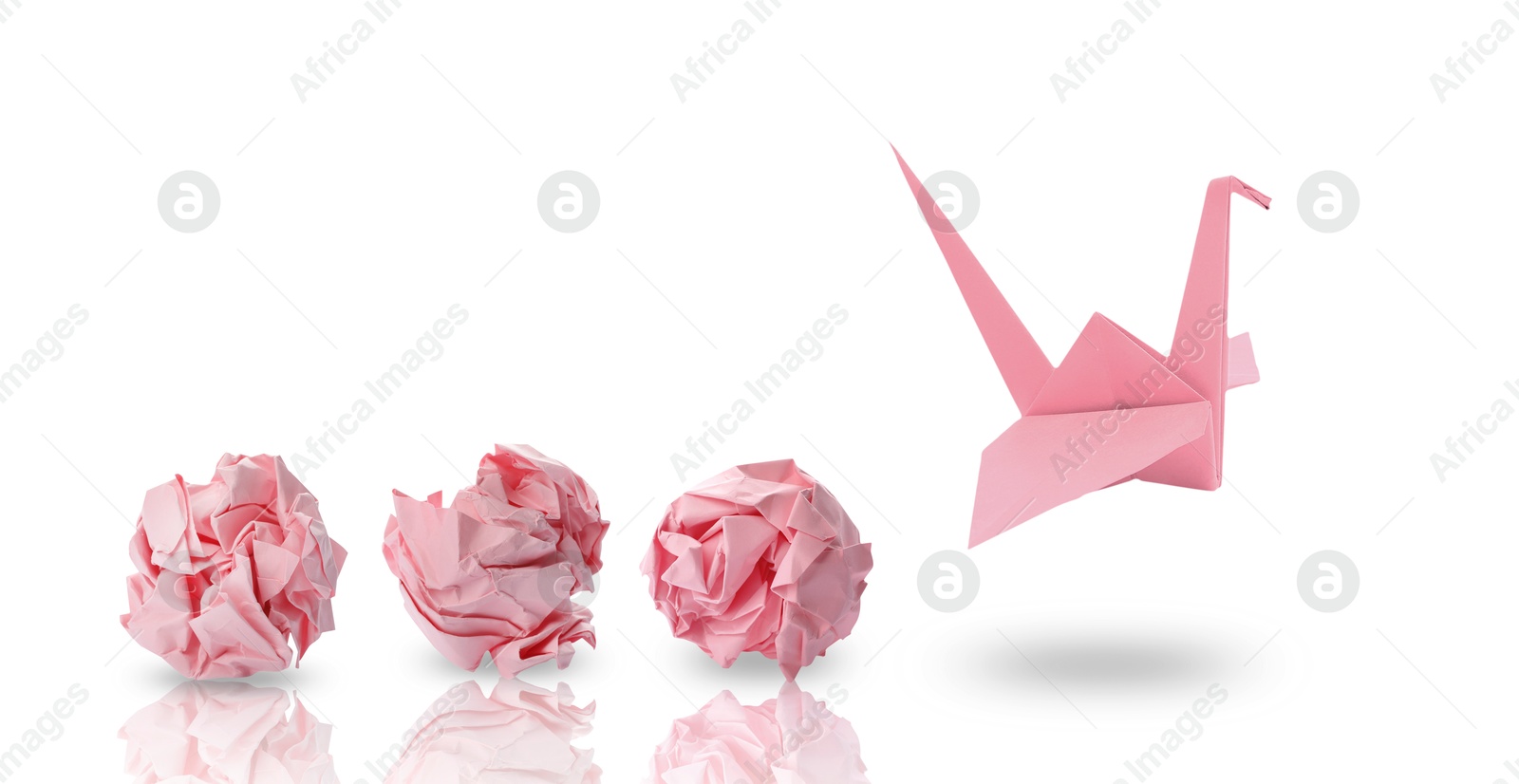 Image of Pink origami crane and crumpled paper balls on white background, banner design. Transformation or new ideas concept