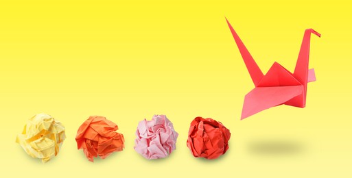 Image of Red origami crane and crumpled paper balls on yellow gradient background, banner design. Transformation or new ideas concept