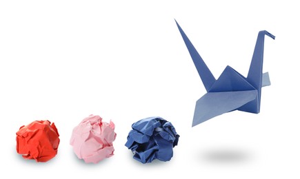 Image of Blue origami crane and crumpled paper balls on white background, banner design. Transformation or new ideas concept