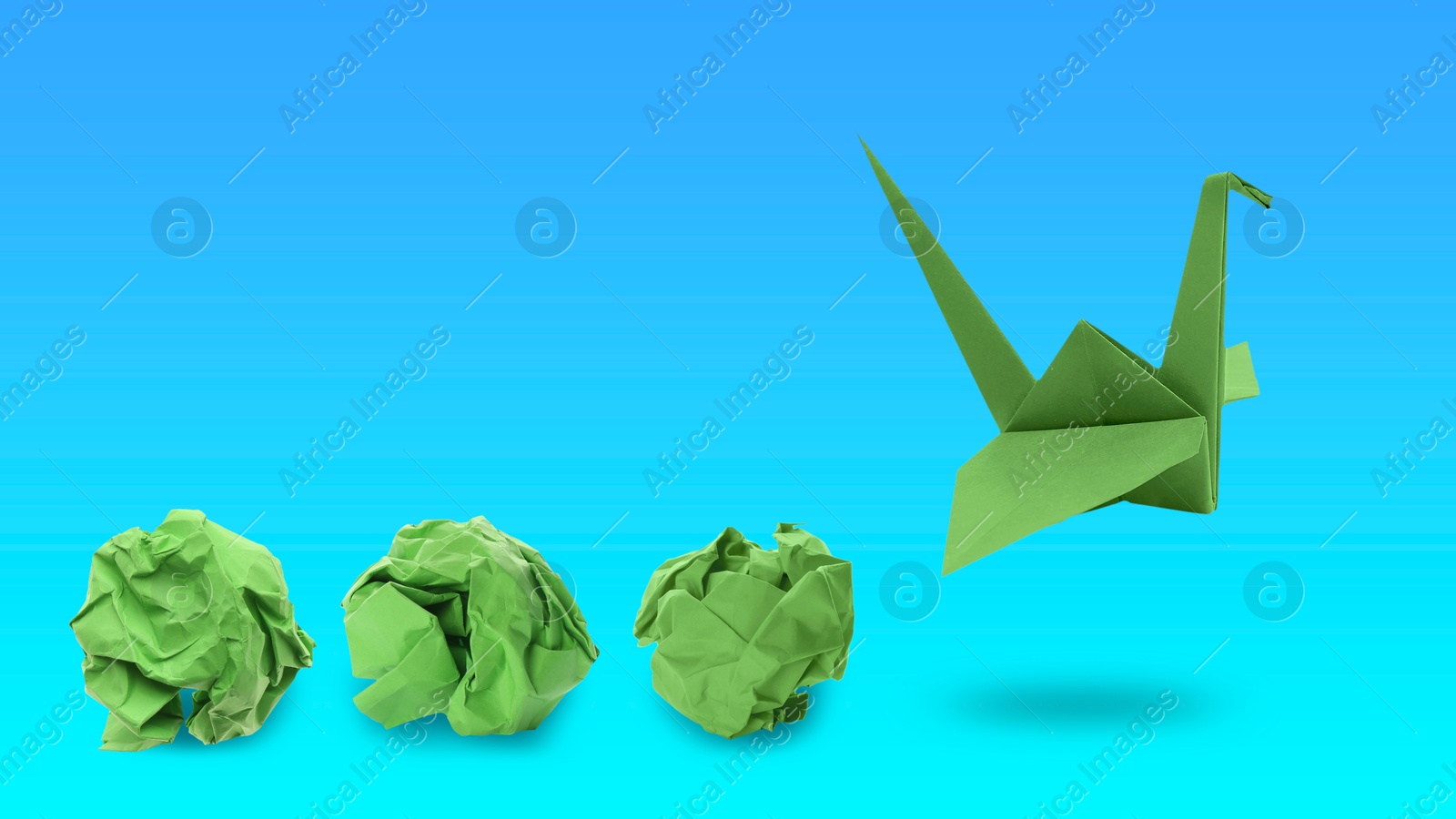 Image of Green origami crane and crumpled paper balls on blue gradient background, banner design. Transformation or new ideas concept