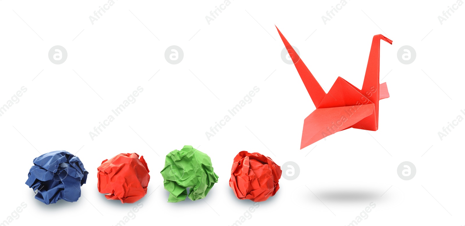 Image of Red origami crane and crumpled paper balls on white background, banner design. Transformation or new ideas concept