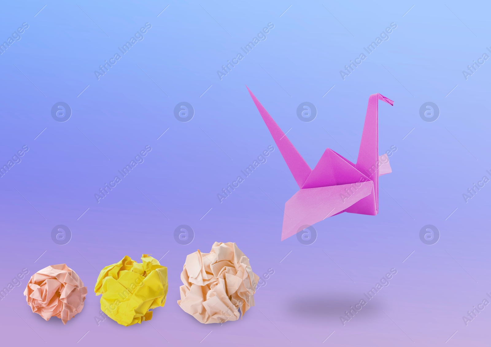 Image of Pink origami crane and crumpled paper balls on violet gradient background. Transformation or new ideas concept