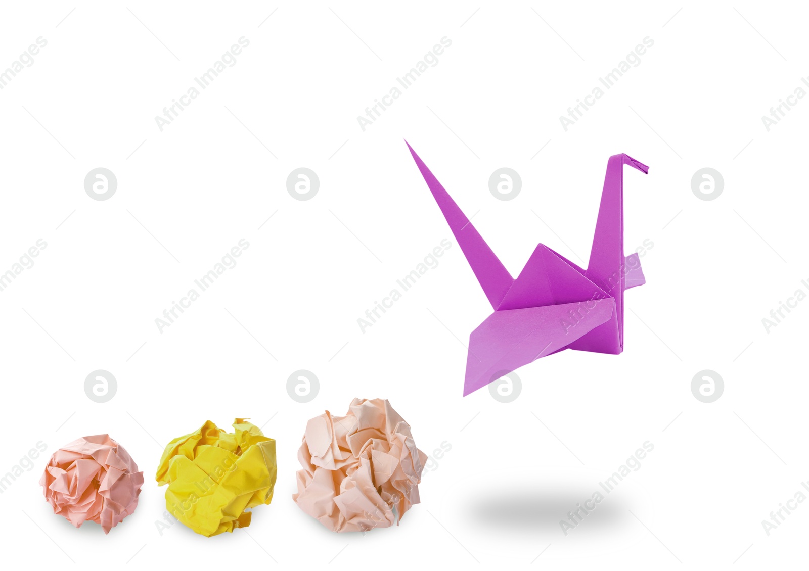 Image of Magenta color origami crane and crumpled paper balls on white background. Transformation or new ideas concept