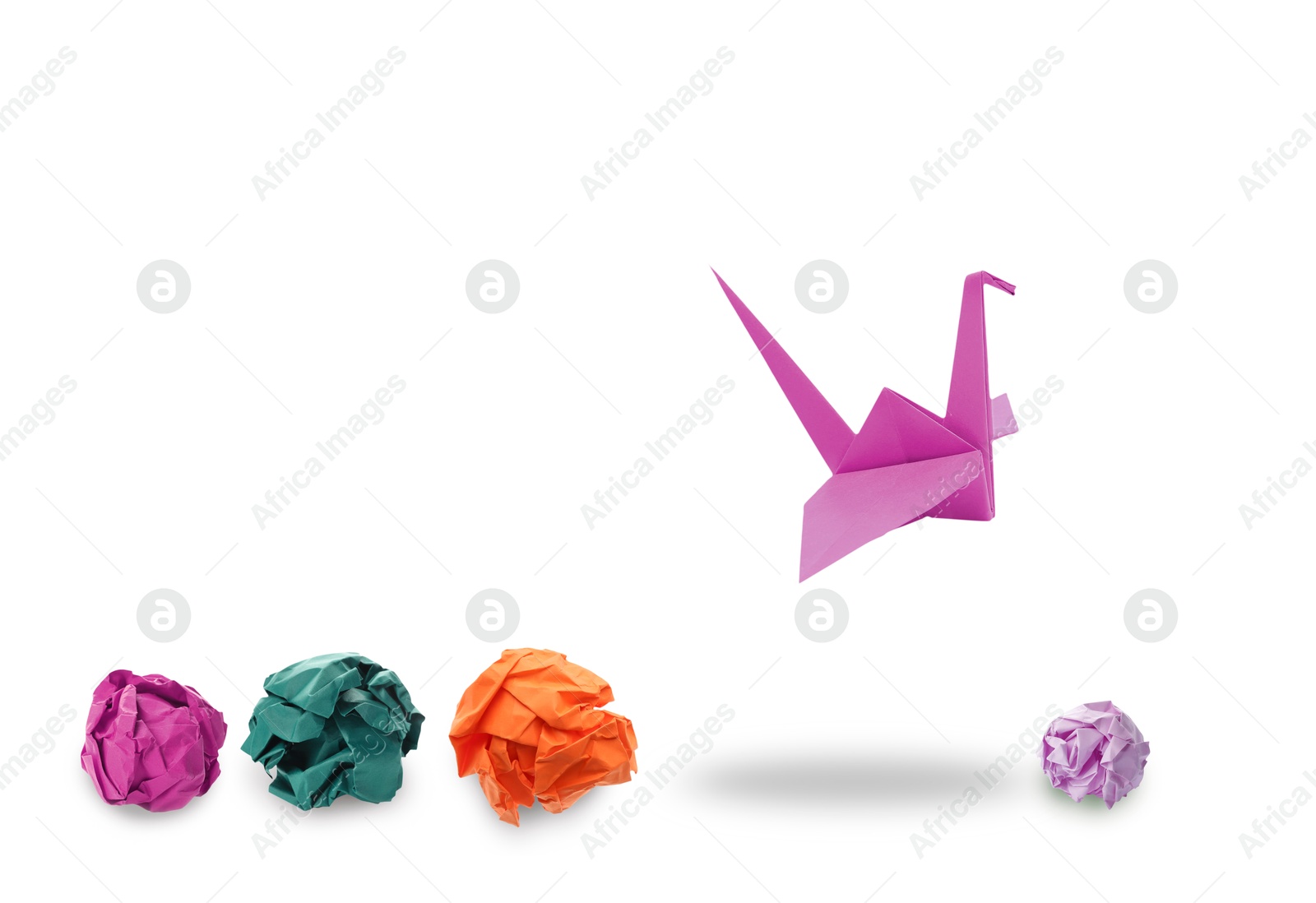 Image of Magenta origami crane and crumpled paper balls on white background. Transformation or leadership concept