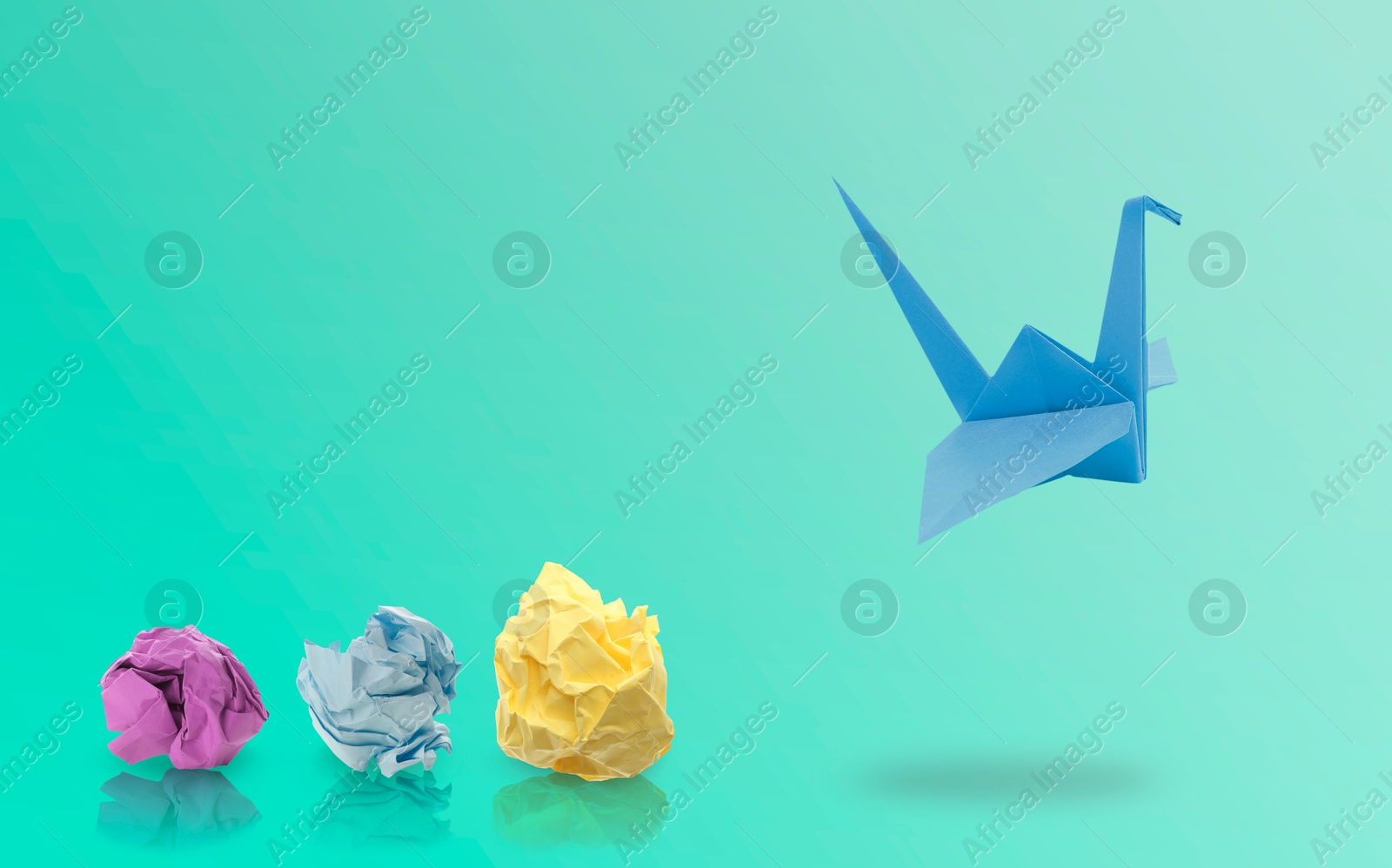 Image of Blue origami crane and crumpled paper balls on turquoise gradient background, banner design. Transformation or new ideas concept