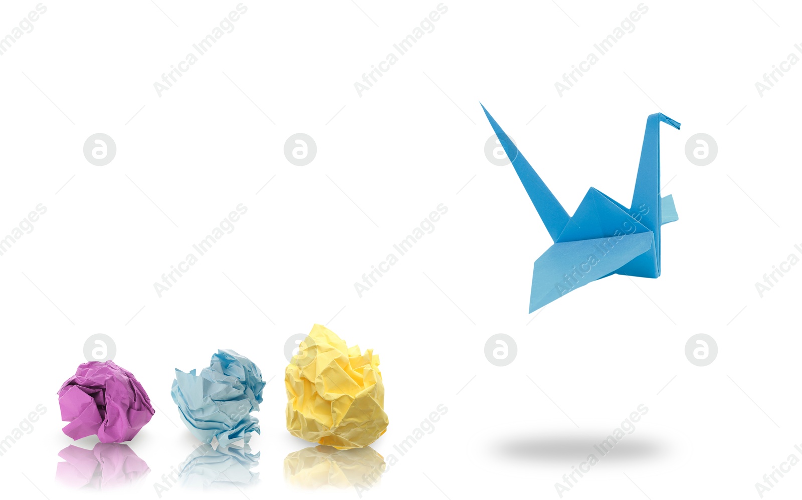 Image of Blue origami crane and crumpled paper balls on white background, banner design. Transformation or new ideas concept