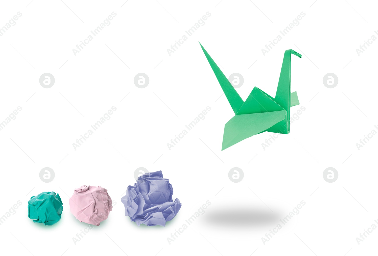 Image of Green origami crane and crumpled paper balls on white background. Transformation or new ideas concept