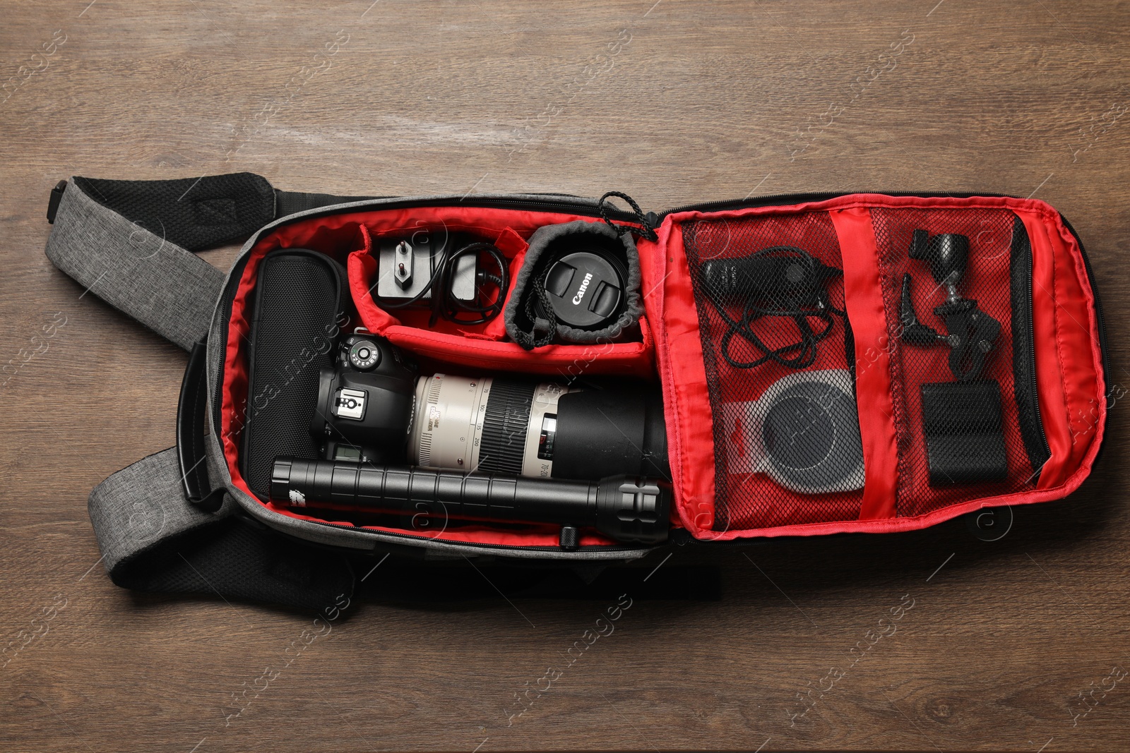 Photo of Photographer's equipment on wooden background, flat lay