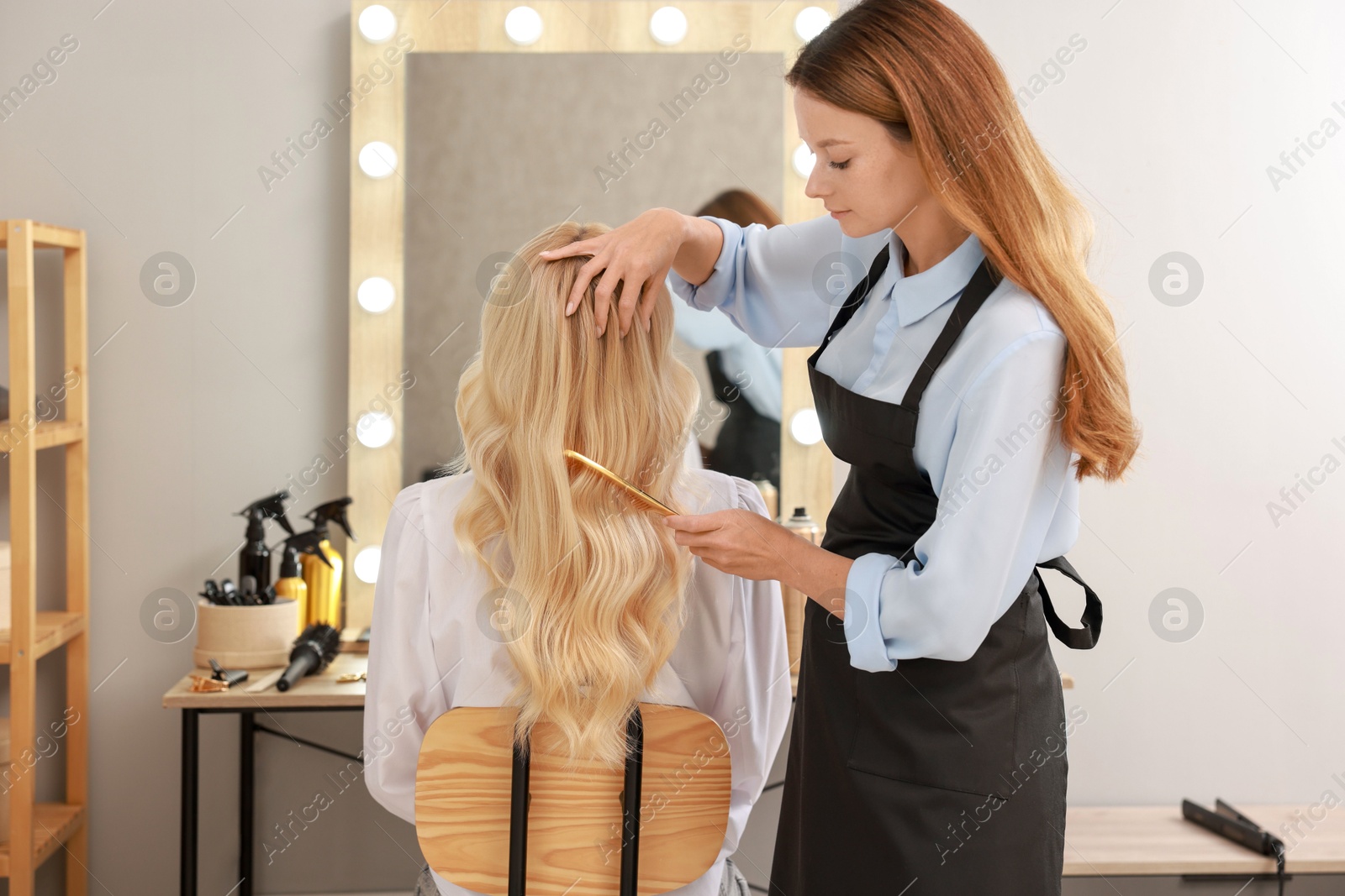 Photo of Hair cutting. Professional hairdresser working with client in salon