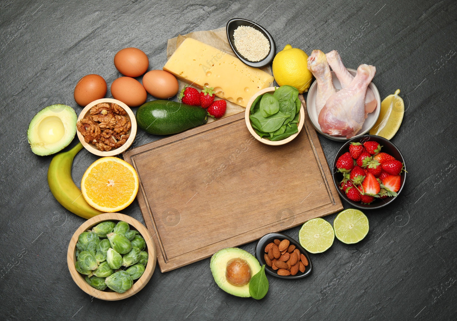 Photo of Wooden board with word Dopamine and different fresh products on grey textured table, flat lay