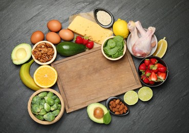 Photo of Wooden board with word Dopamine and different fresh products on grey textured table, flat lay